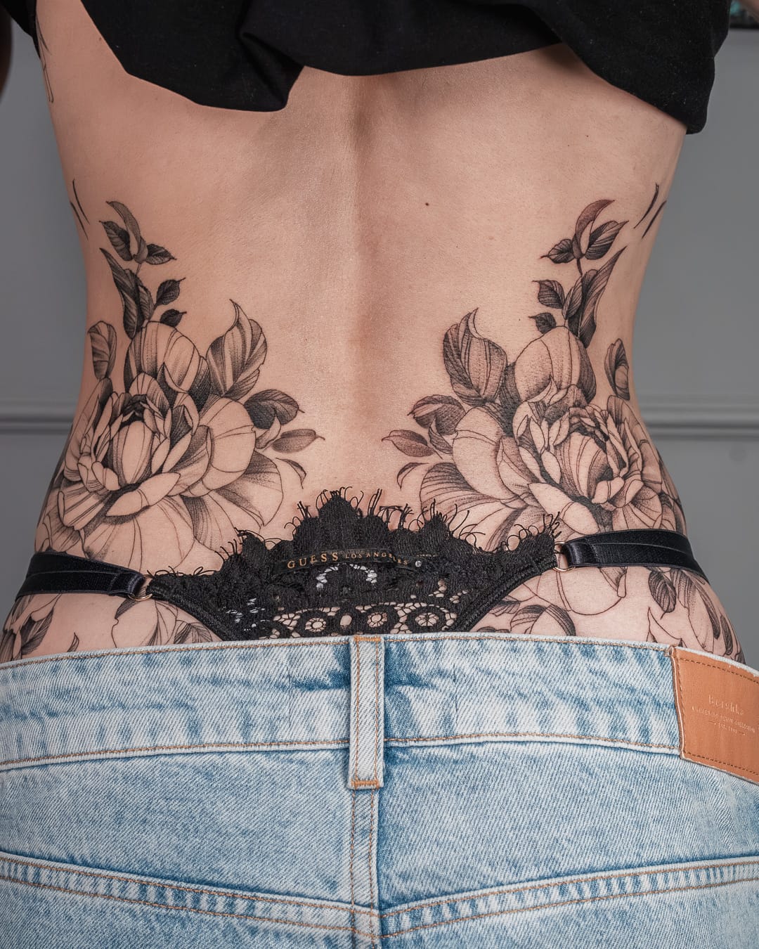 Fine line botanical tattoo — editorial composition
